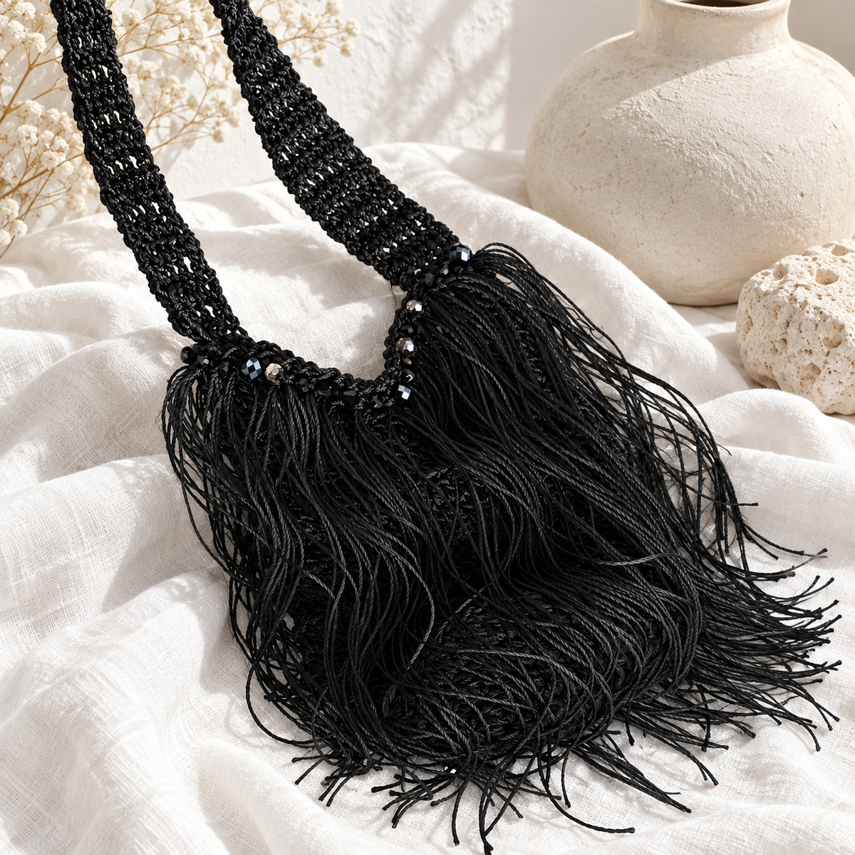 Cartera negra de crochet con flecos y detalles de cristales, tejida a mano en Puerto Rico.