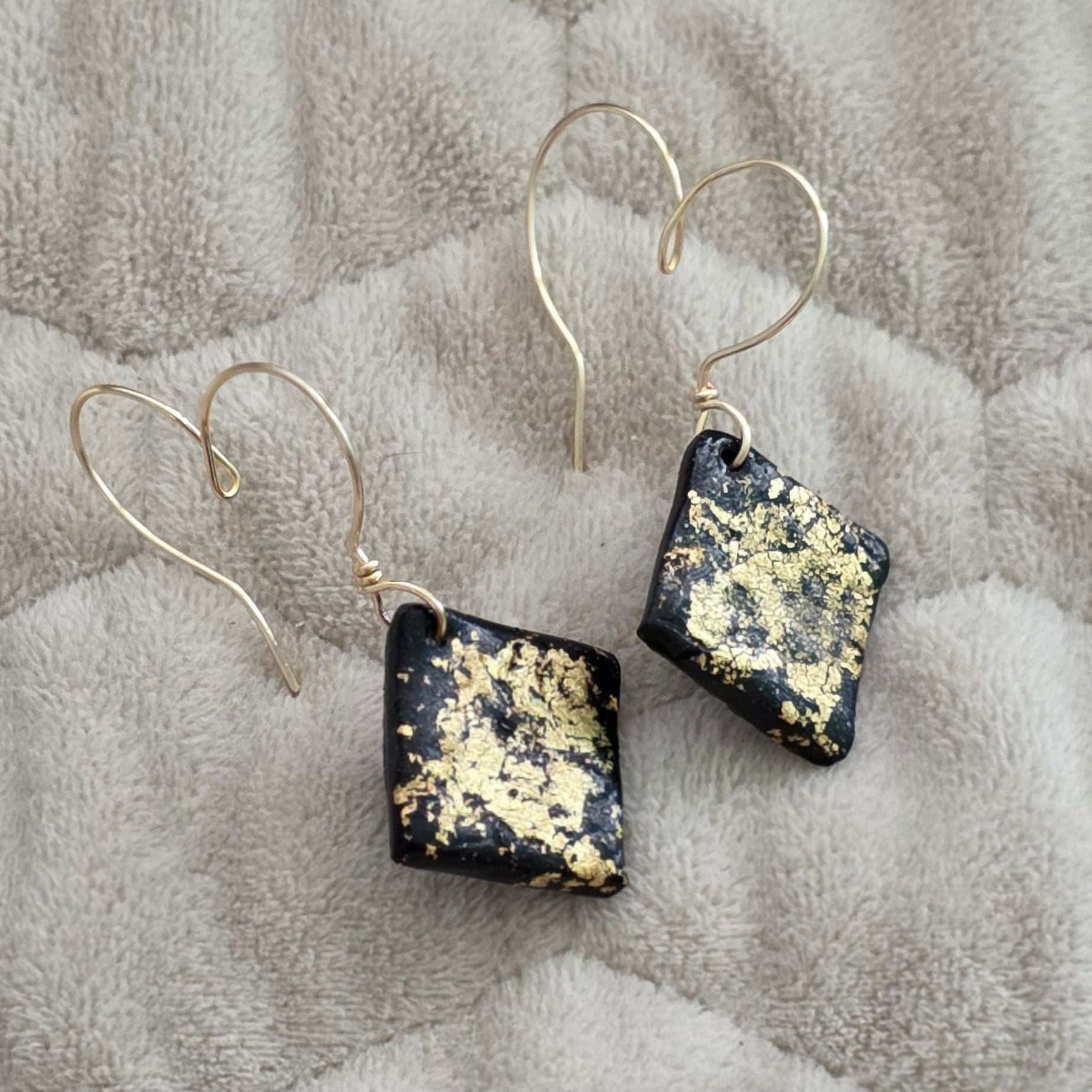 polymer clay earrings, black earrings, gold earrings, geometric earrings, handmade earrings, artisan jewelry, statement earrings, modern earrings, minimalist jewelry, dangle earrings, elegant earrings, unique earrings