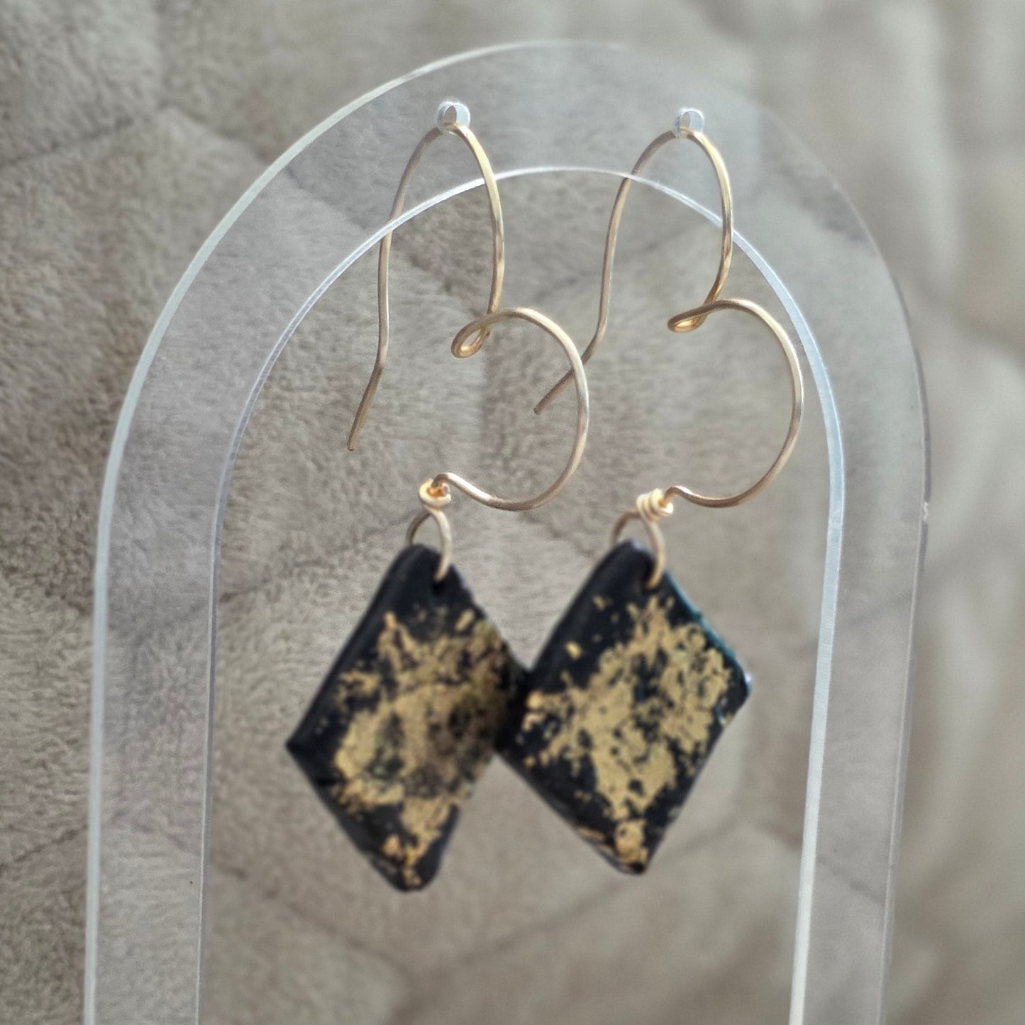 polymer clay earrings, black earrings, gold earrings, geometric earrings, handmade earrings, artisan jewelry, statement earrings, modern earrings, minimalist jewelry, dangle earrings, elegant earrings, unique earrings