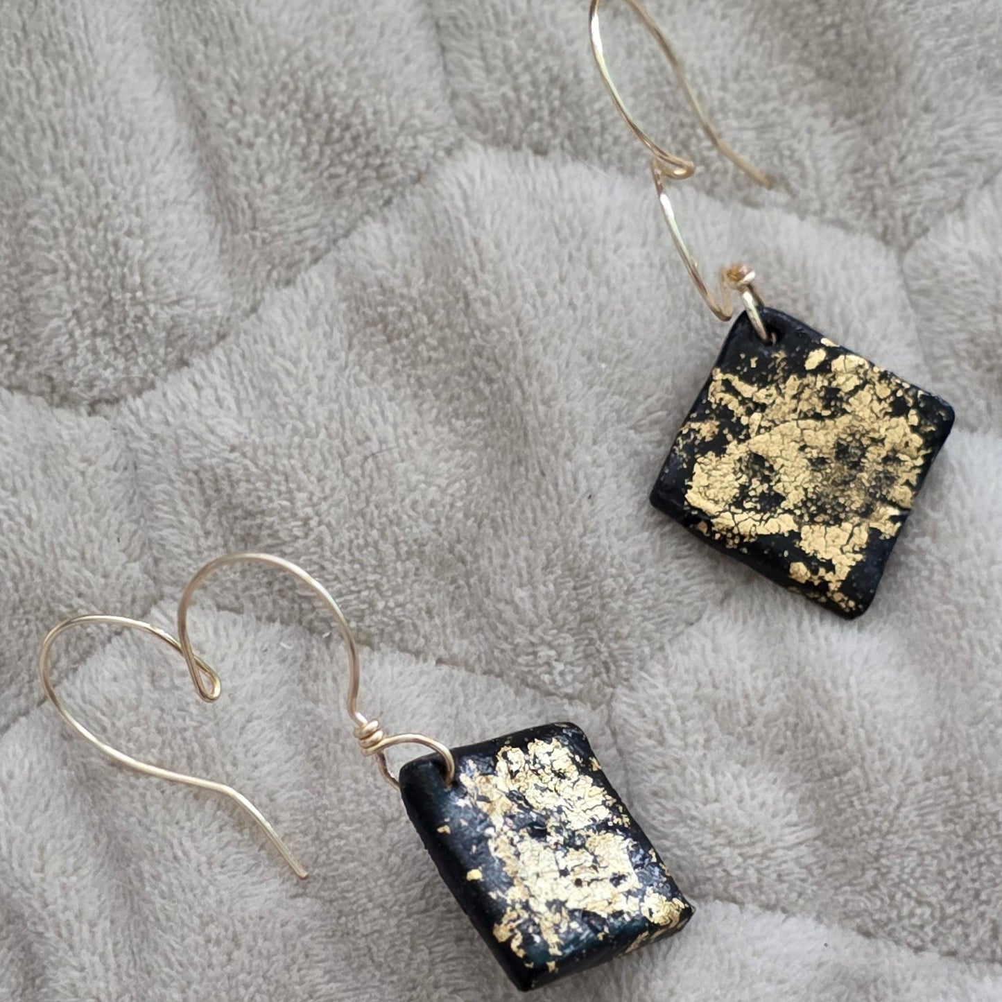 polymer clay earrings, black earrings, gold earrings, geometric earrings, handmade earrings, artisan jewelry, statement earrings, modern earrings, minimalist jewelry, dangle earrings, elegant earrings, unique earrings