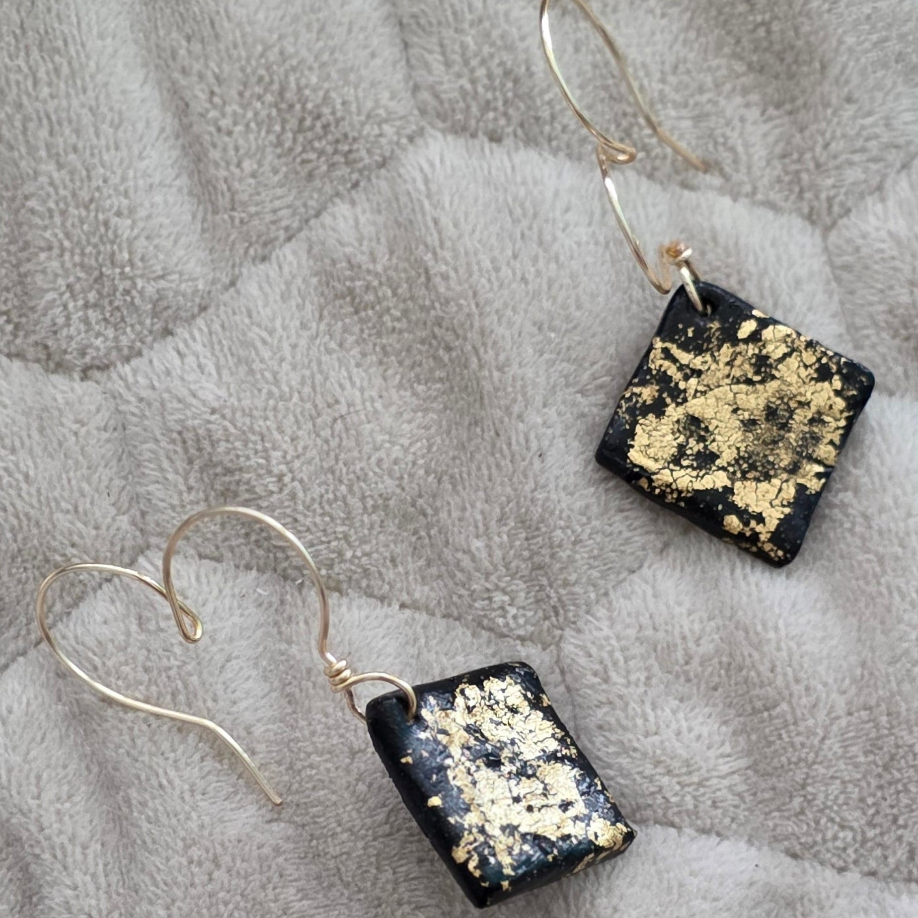 polymer clay earrings, black earrings, gold earrings, geometric earrings, handmade earrings, artisan jewelry, statement earrings, modern earrings, minimalist jewelry, dangle earrings, elegant earrings, unique earrings