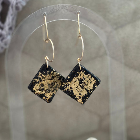 polymer clay earrings, black earrings, gold earrings, geometric earrings, handmade earrings, artisan jewelry, statement earrings, modern earrings, minimalist jewelry, dangle earrings, elegant earrings, unique earrings